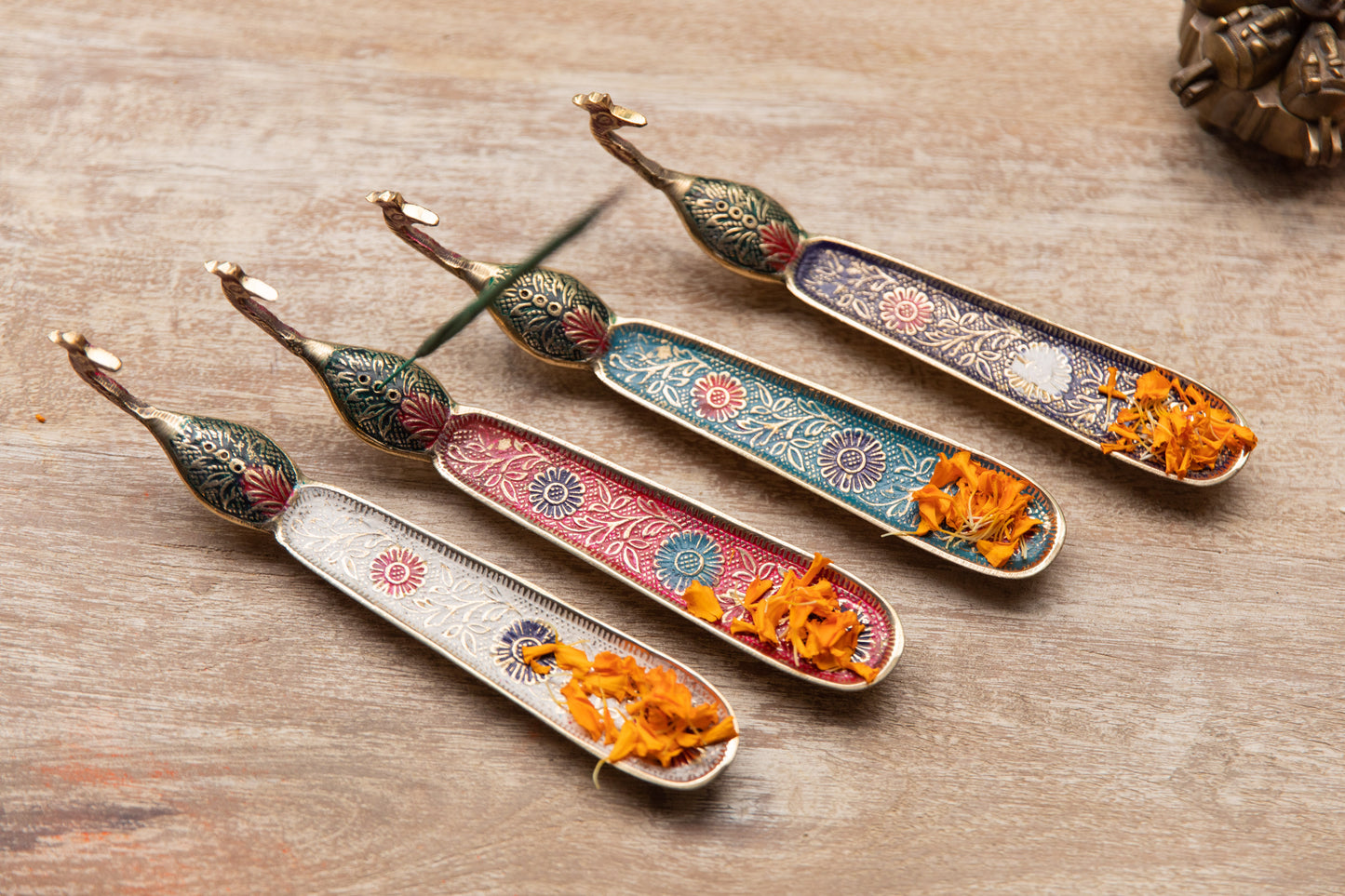 A Delicate brass incense Stick holder With A Peacock Handle Detail.
