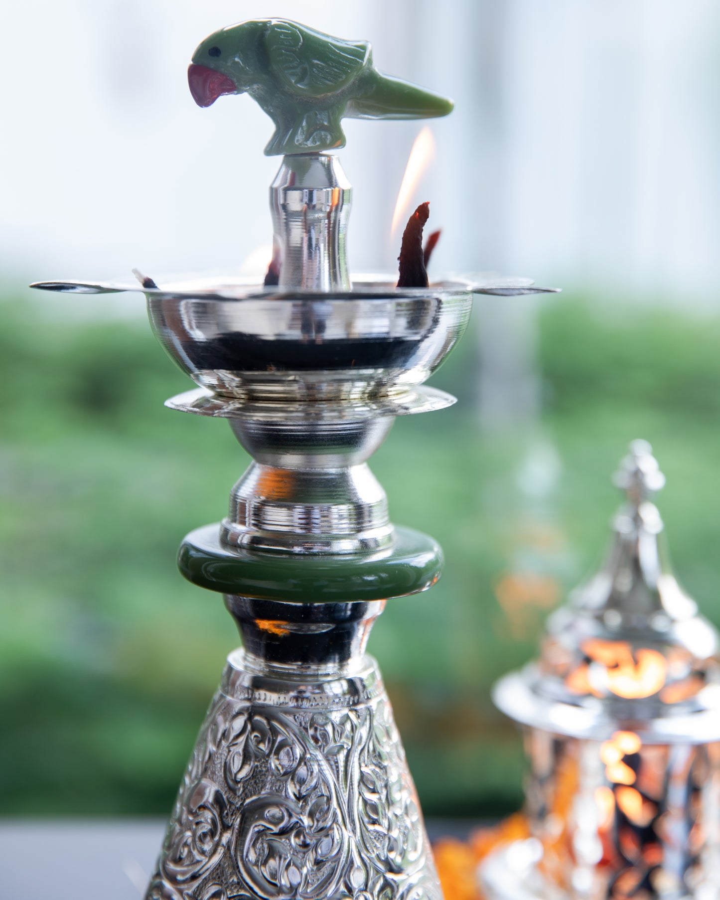 Crafted from high-quality silver, this tall diya radiates a lustrous and timeless glow when lit.