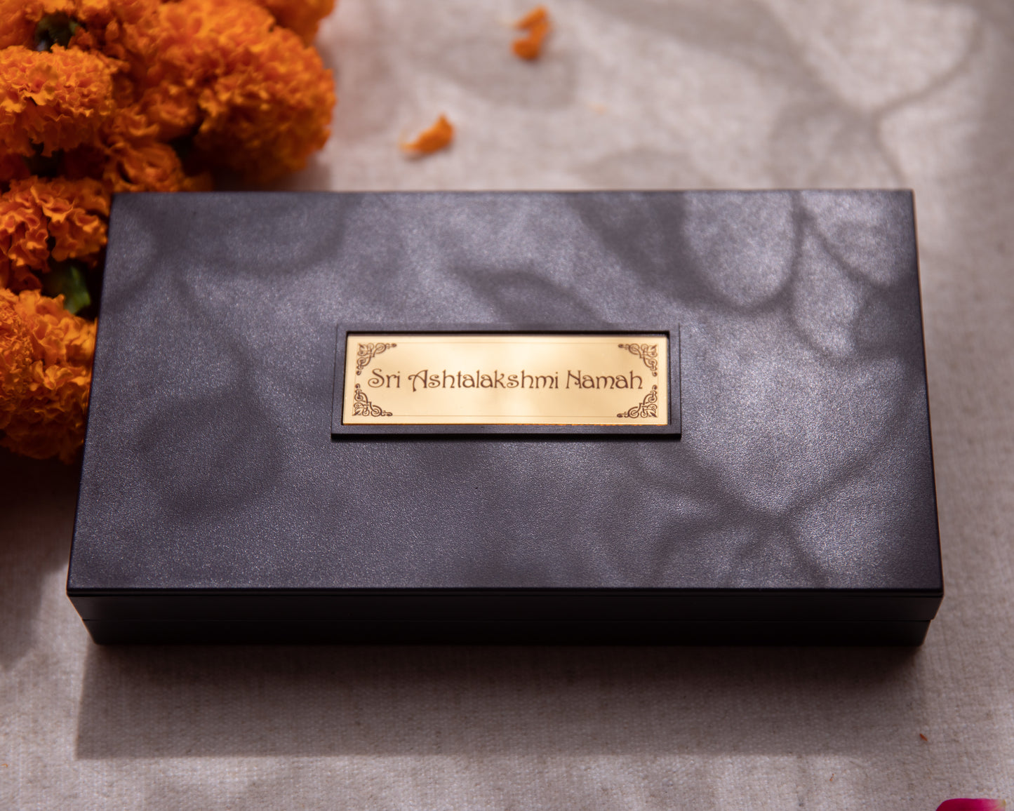 This Pooja Box is made from wood, all the symbolism and imagery seen within has been wrapped in 24KT gold foil.