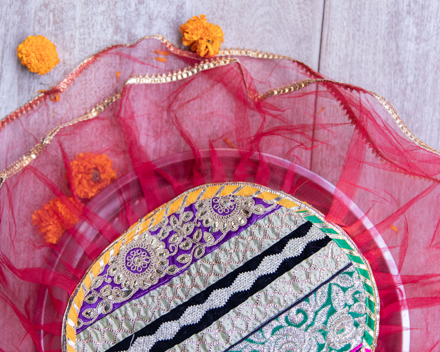 Our Gota Patti Thali Cover is adorned with exquisite Gota Patti work, a traditional Indian craft known for its intricate designs and embellishments.