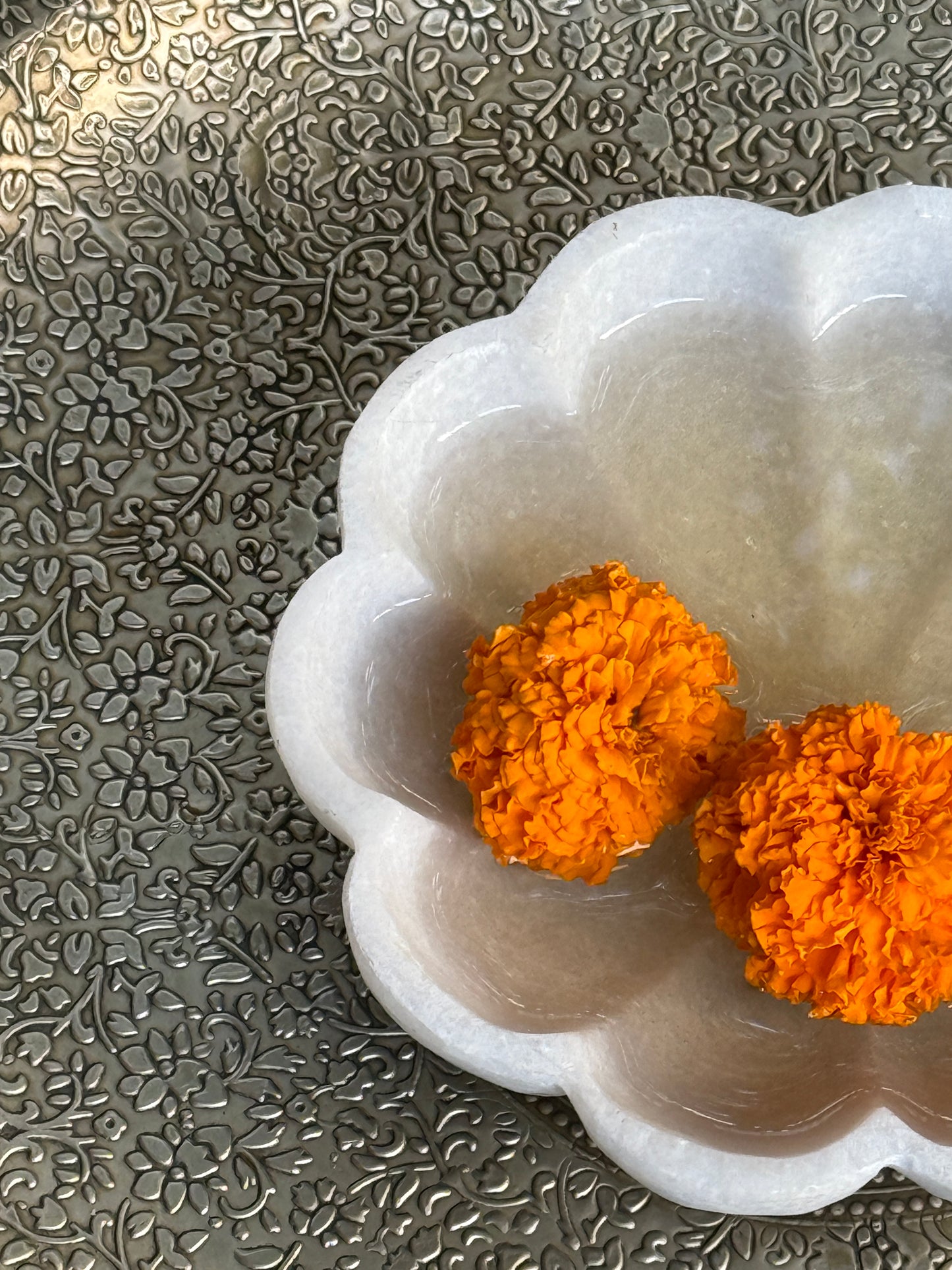 Handcrafted from premium white marble, this elegant floral marble urli adds a serene and timeless charm to your sacred space.