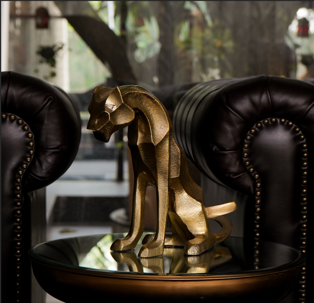 Our Majestic Nera Cheetah Sculpture, expertly crafted from sturdy metal and coated with a lustrous brass polish. This captivating piece captures the essence of the cheetah's grace and power, making it a stunning addition to any decor.
