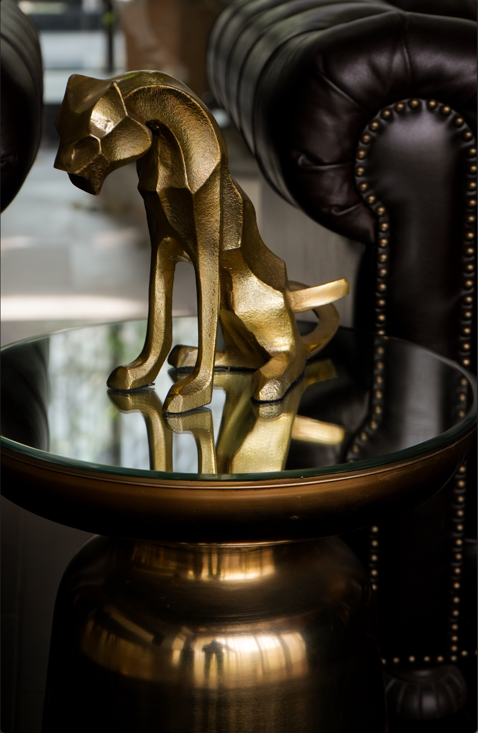 Our Majestic Nera Cheetah Sculpture, expertly crafted from sturdy metal and coated with a lustrous brass polish. This captivating piece captures the essence of the cheetah's grace and power, making it a stunning addition to any decor.