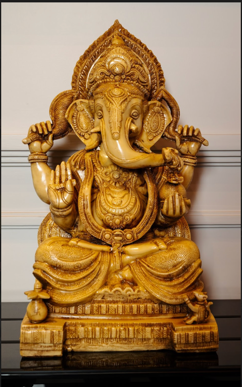 The beautifully detailed Ganesh idol exudes serenity and grace, symbolizing wisdom, prosperity, and the removal of obstacles. Complementing the idol, the camel bone tusks add a regal touch to your decor.