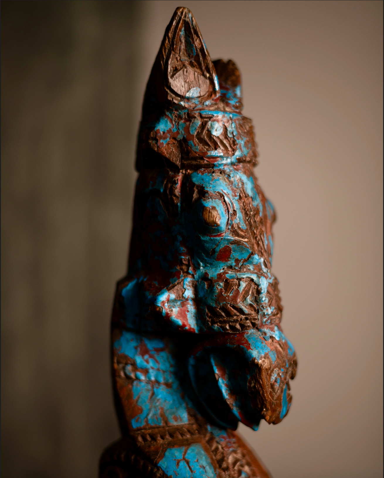 The Neelashva is a hand-carved wooden horse head sculpture, brought to life with a rare plant-based turquoise blue patina. Once part of an architectural fragment, its bold lines and ornate detailing reflect strength, vitality, and auspicious symbolism.