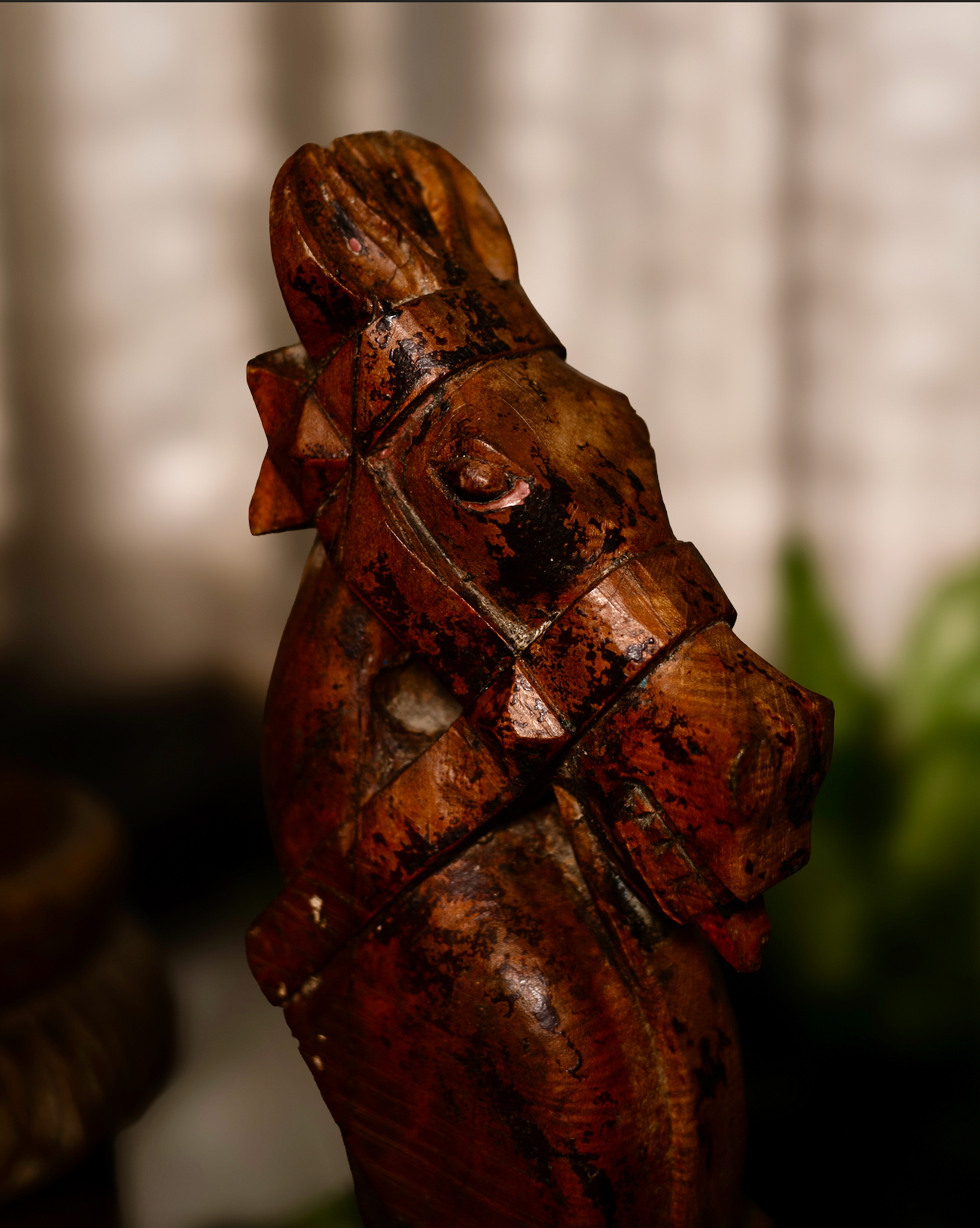 The Ashva Shilp is a hand-carved wooden horse head sculpture that embodies strength and vitality. With its natural orange patina and the striking detail of a pink-painted tongue, this salvaged fragment carries both character and charm.