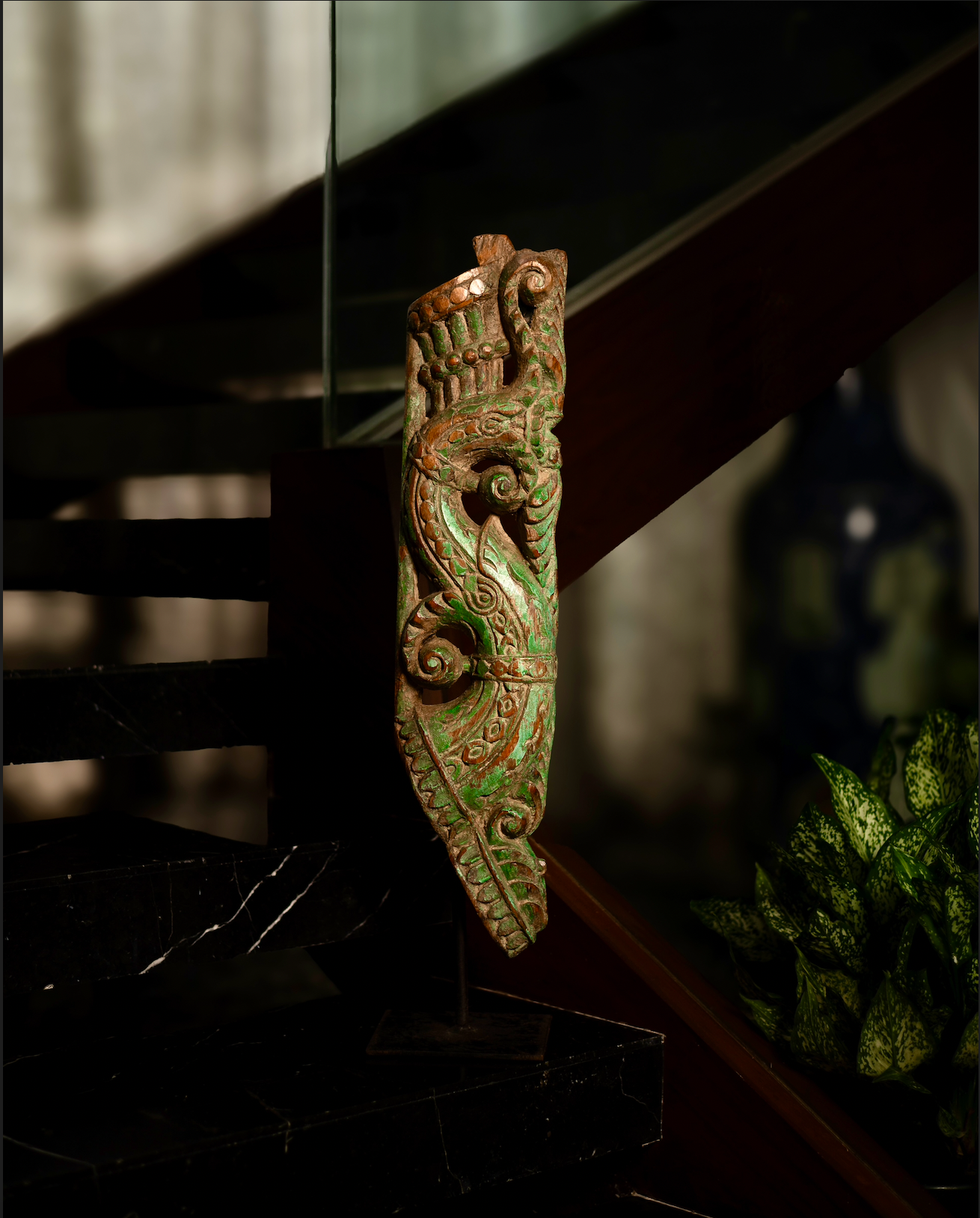 The Kritika brackets are salvaged fragments of heritage architecture, hand-carved from solid wood and finished with natural plant-based colors. Each piece is unique — Kritika I in deep green tones and Kritika II in earthy terracotta with teal accents