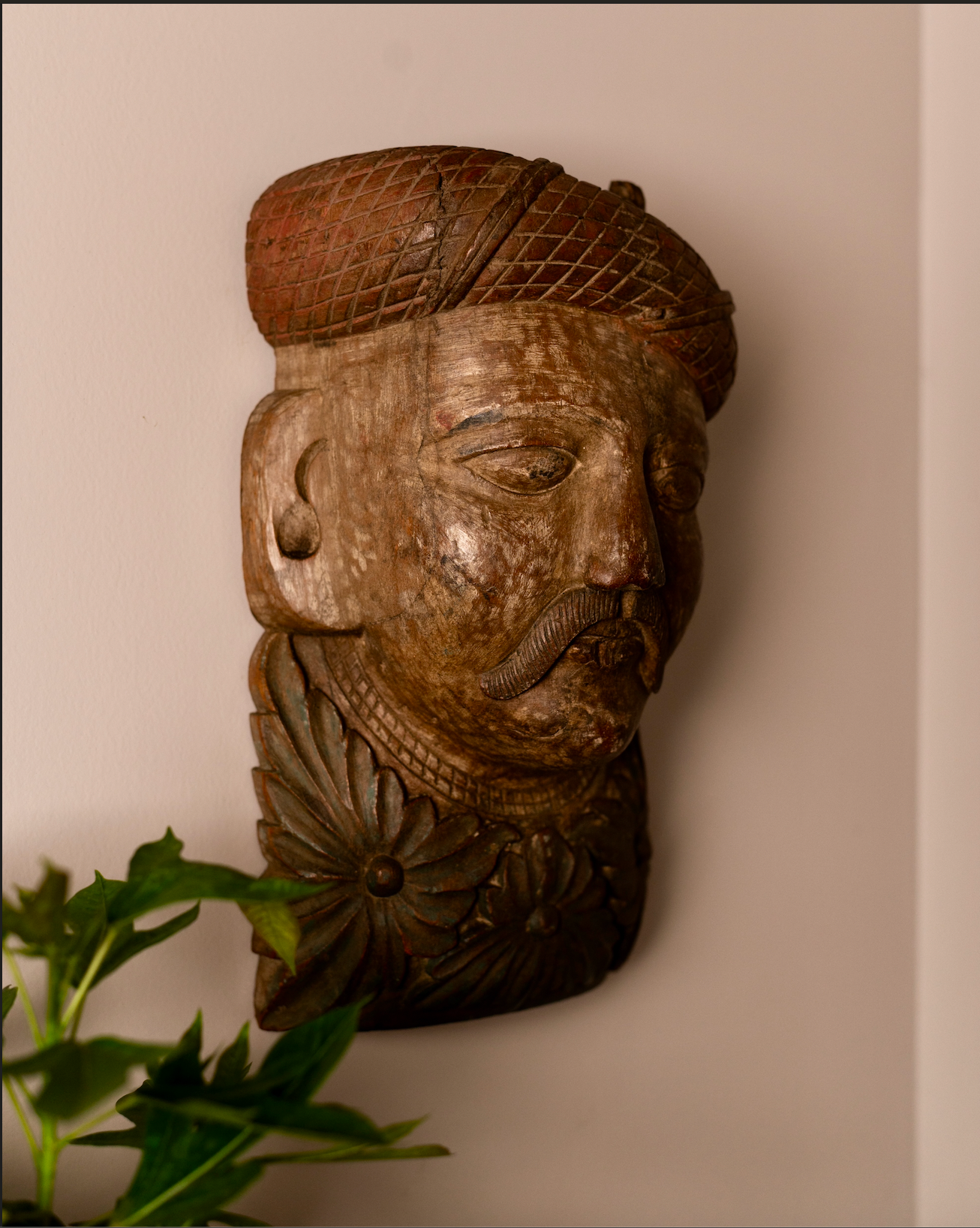 Carved from solid wood, the Veer Mukhā Wall Sculpture carries the regal presence of a bygone era. With its hand-detailed turban, mustache, and floral base, it reflects the strength and dignity of traditional Indian guardians often found in havelis and temples