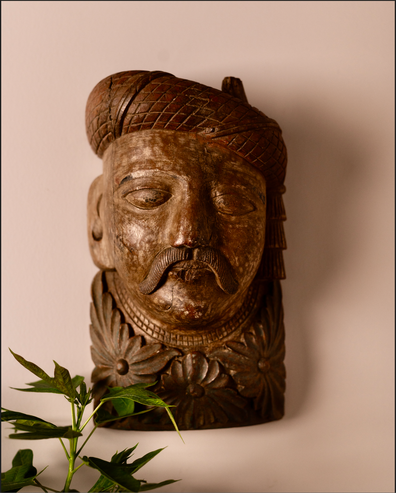 Carved from solid wood, the Veer Mukhā Wall Sculpture carries the regal presence of a bygone era. With its hand-detailed turban, mustache, and floral base, it reflects the strength and dignity of traditional Indian guardians often found in havelis and temples