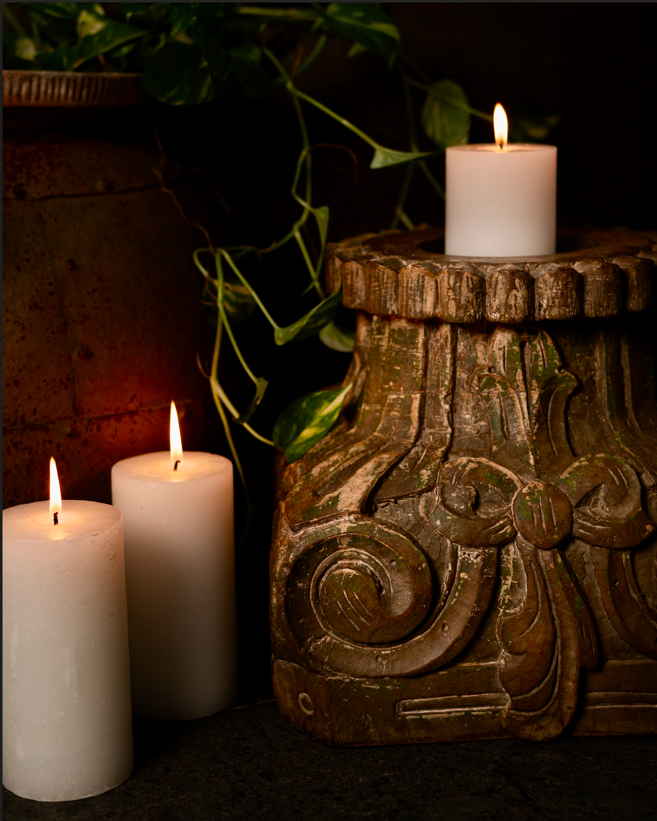 The Harita Stambh Candle Pedestal echoes the grandeur of old-world architecture, carved by hand from solid wood and finished with natural, plant-based green hues.
