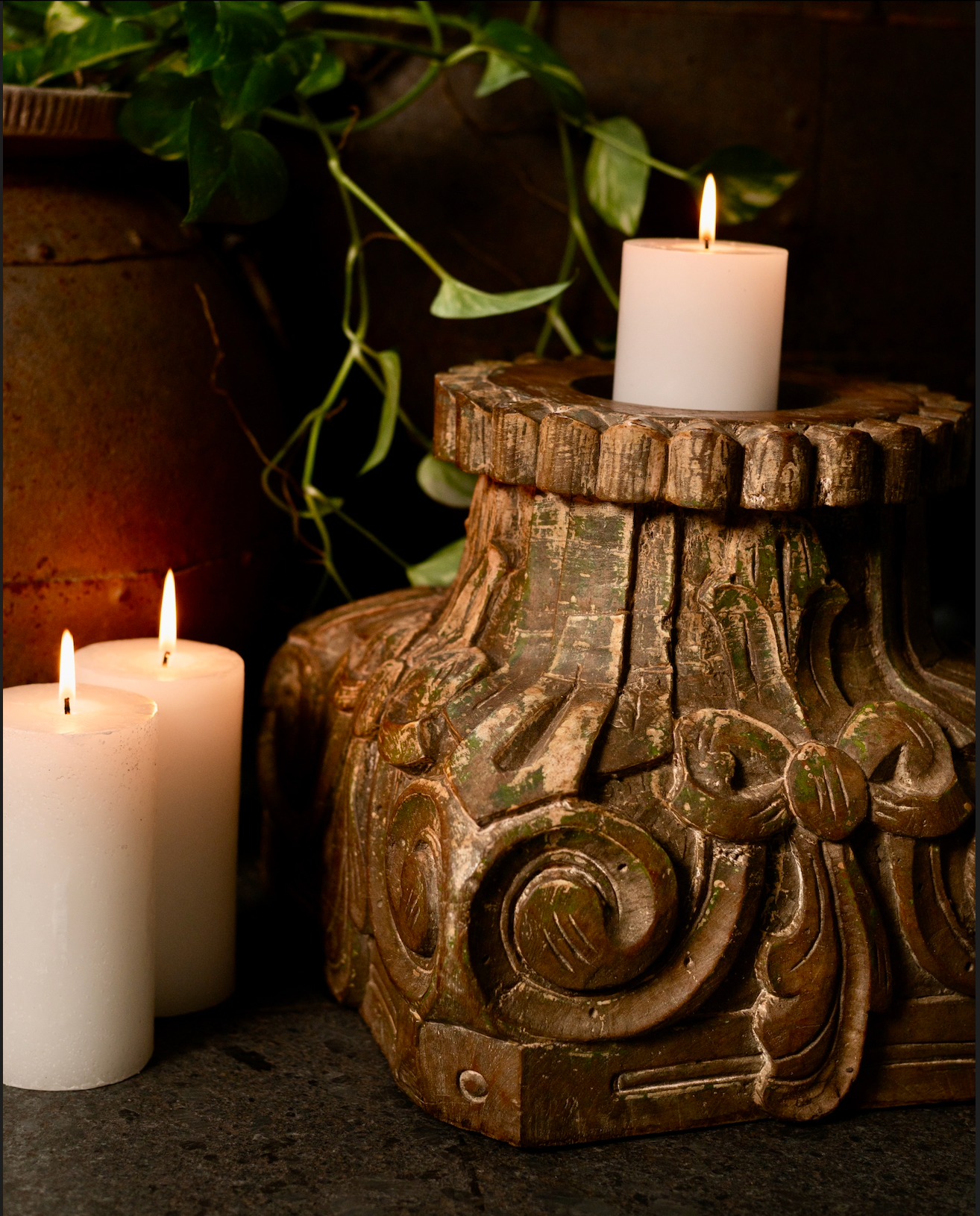 The Harita Stambh Candle Pedestal echoes the grandeur of old-world architecture, carved by hand from solid wood and finished with natural, plant-based green hues.