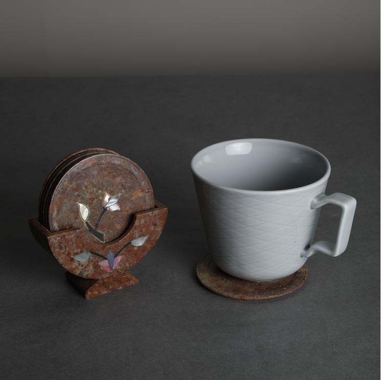 A stone coasters set with an semi precious stone dust inlay detail, along with a stone coaster stand to bring in a royal & elegant feel to serving your guests drinks in style.