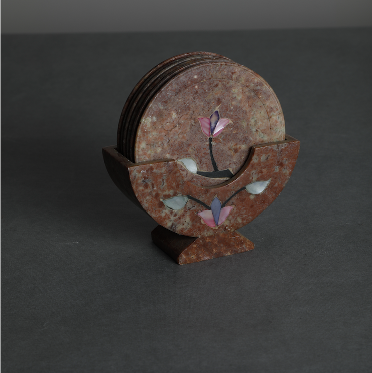 A stone coasters set with an semi precious stone dust inlay detail, along with a stone coaster stand to bring in a royal & elegant feel to serving your guests drinks in style.