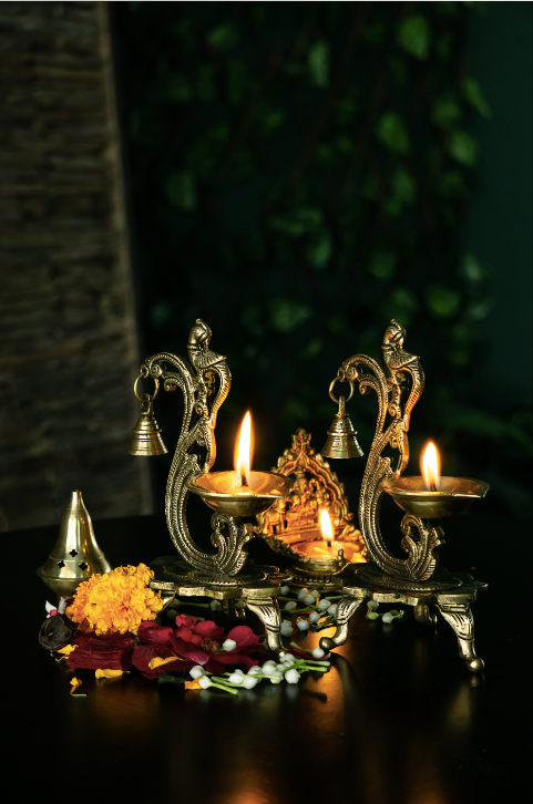 Brass Diyas with a bell Detail with an antique gold finish.