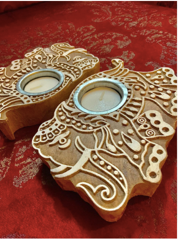 Imprint block Tea Light holders are Made of 100% sheesham Wood & are Available as a set of 2. these come in floral & elephant patterns.