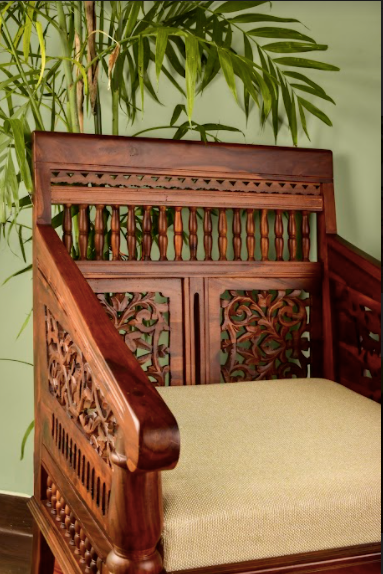 A Chair Made of mango wood, the chair is hand-carved with intricate details inspired by royal living.