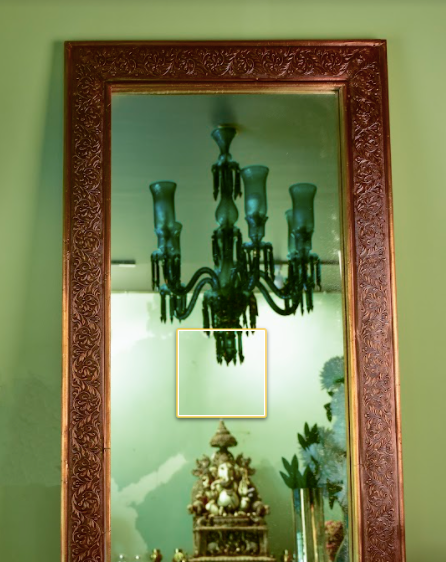 A Glorious Antique Wall Mirror, With the frame made wit Brass in an antique finish with delicate carvings all over the brass frame.