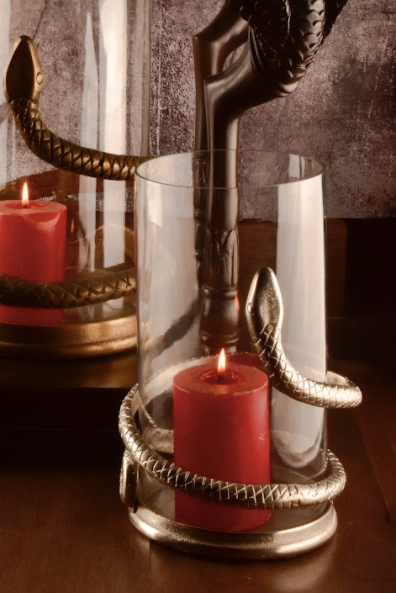 A Candle Stand Made With A Clear Glass Body Wrapped With A Snake Detail In A Rustic Silver & Gold Finish.