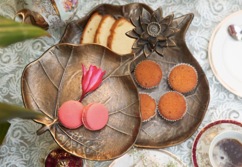 A 2-Tier, Rustic Metallic Food Stand In The Image Of A Petal With A Pencil Candle Holder.