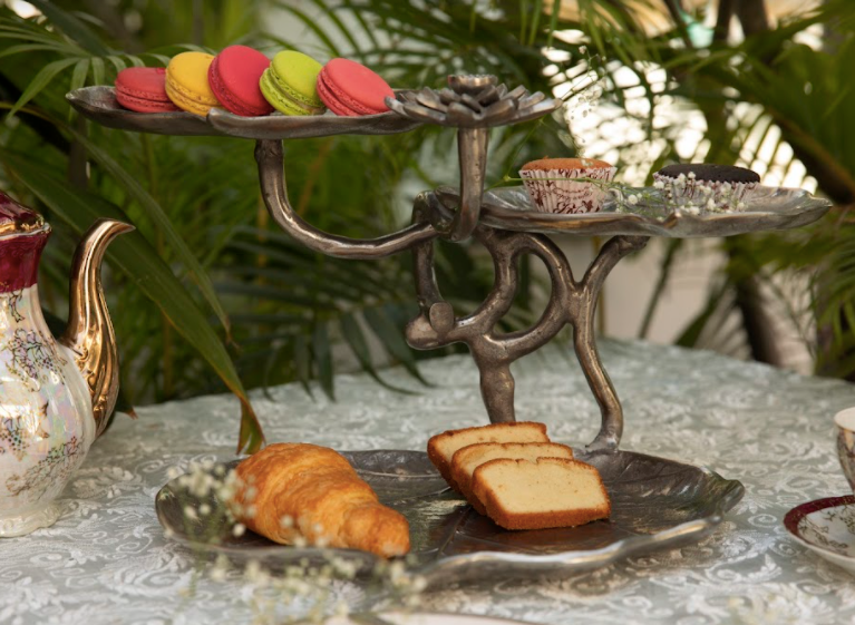 A 3-Tier, Rustic Metallic Food Stand In The Image Of A Petal With A Pencil Candle Holder.