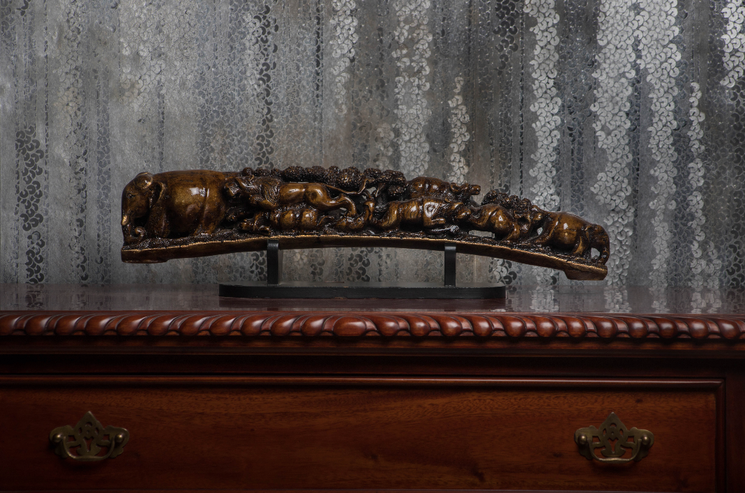 A Beautifully carved camel bone tusk, with carving inspirations from the abundance of history in the many many caves of india.