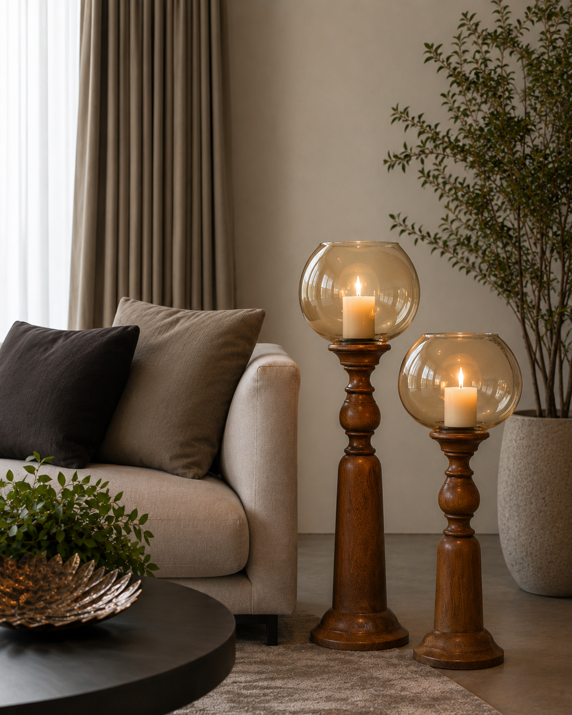 Turned wooden candle stands topped with hand-blown amber glass globes, designed to hold pillar candles at a graceful height. 