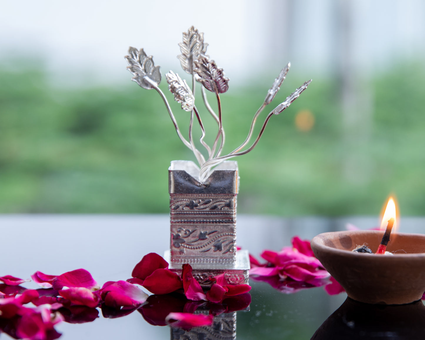 Our Silver Plated Tulsi Plant, meticulously crafted to capture the essence of the Tulsi plant, with intricate leaves and branches that reflect the richness of tradition.