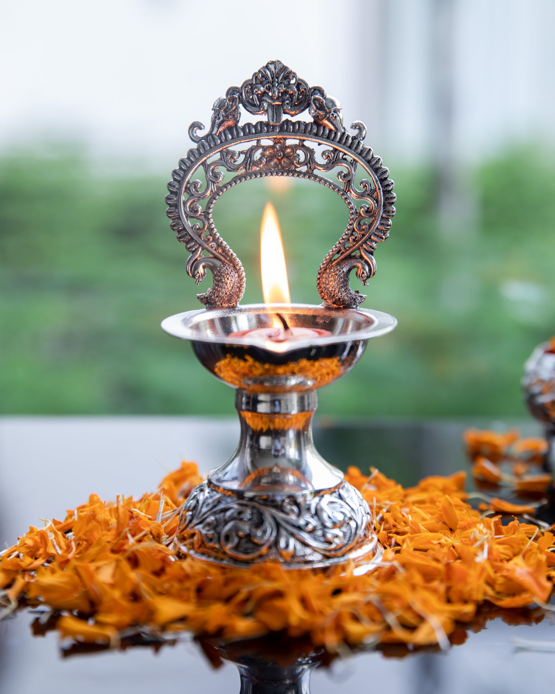 Prabhavali Diya is coated with high-quality silver, this diya radiates a lustrous and timeless glow when lit.