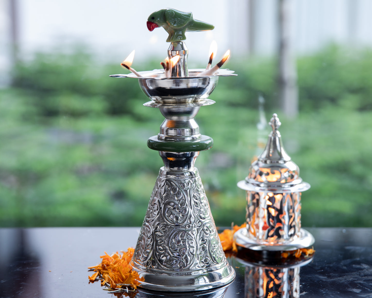 Crafted from high-quality silver, this tall diya radiates a lustrous and timeless glow when lit.