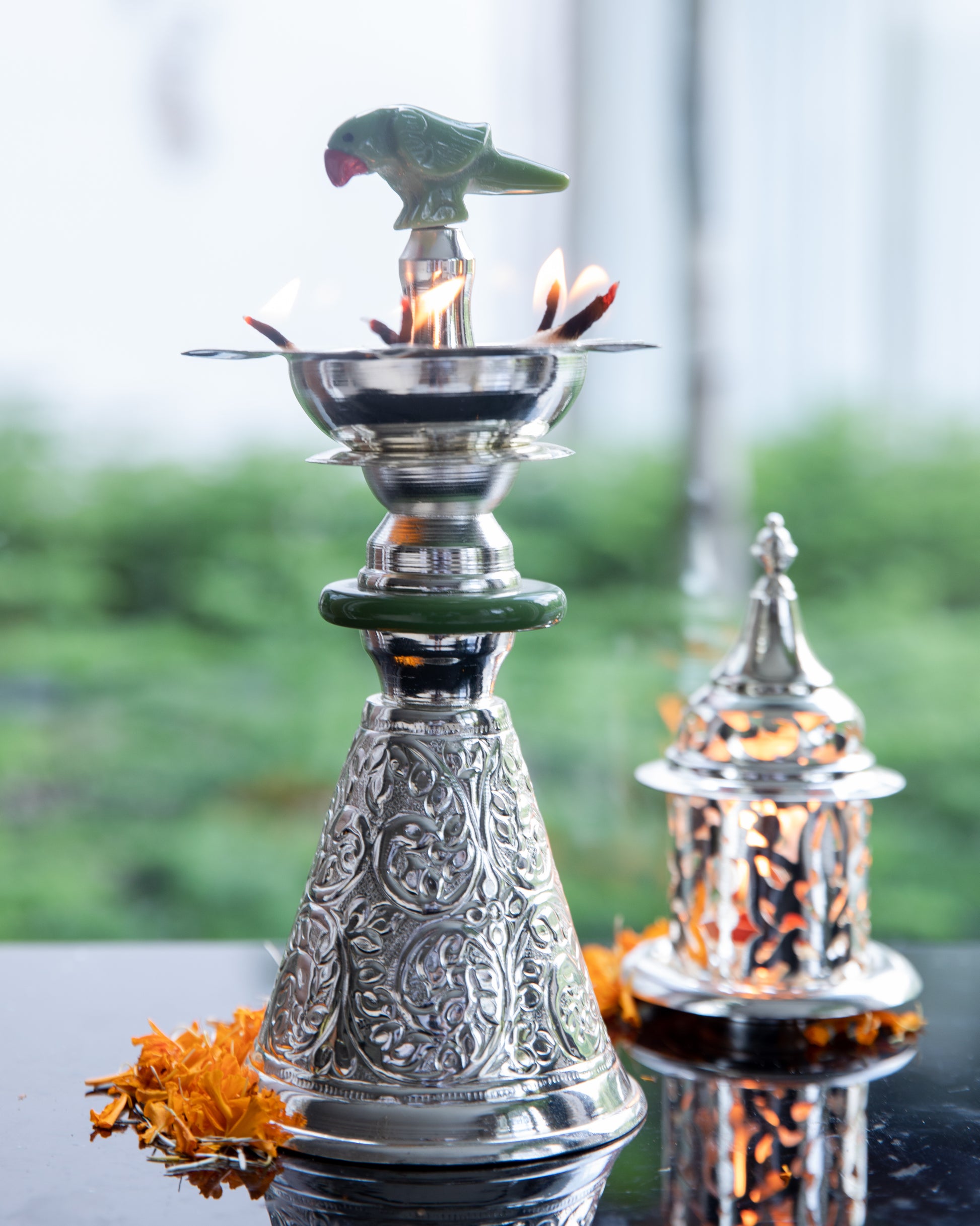 Crafted from high-quality silver, this tall diya radiates a lustrous and timeless glow when lit.