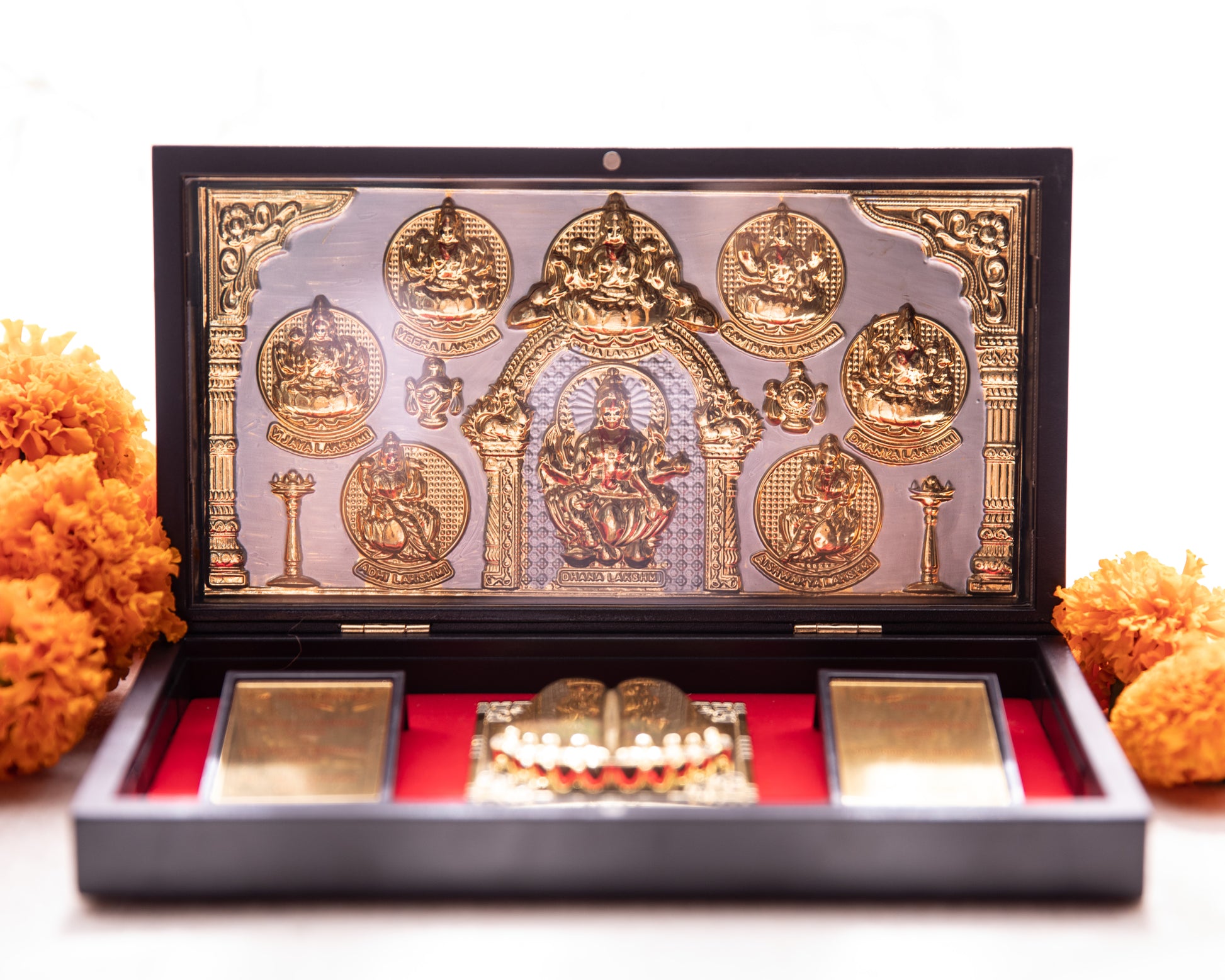 This Pooja Box is made from wood, all the symbolism and imagery seen within has been wrapped in 24KT gold foil.