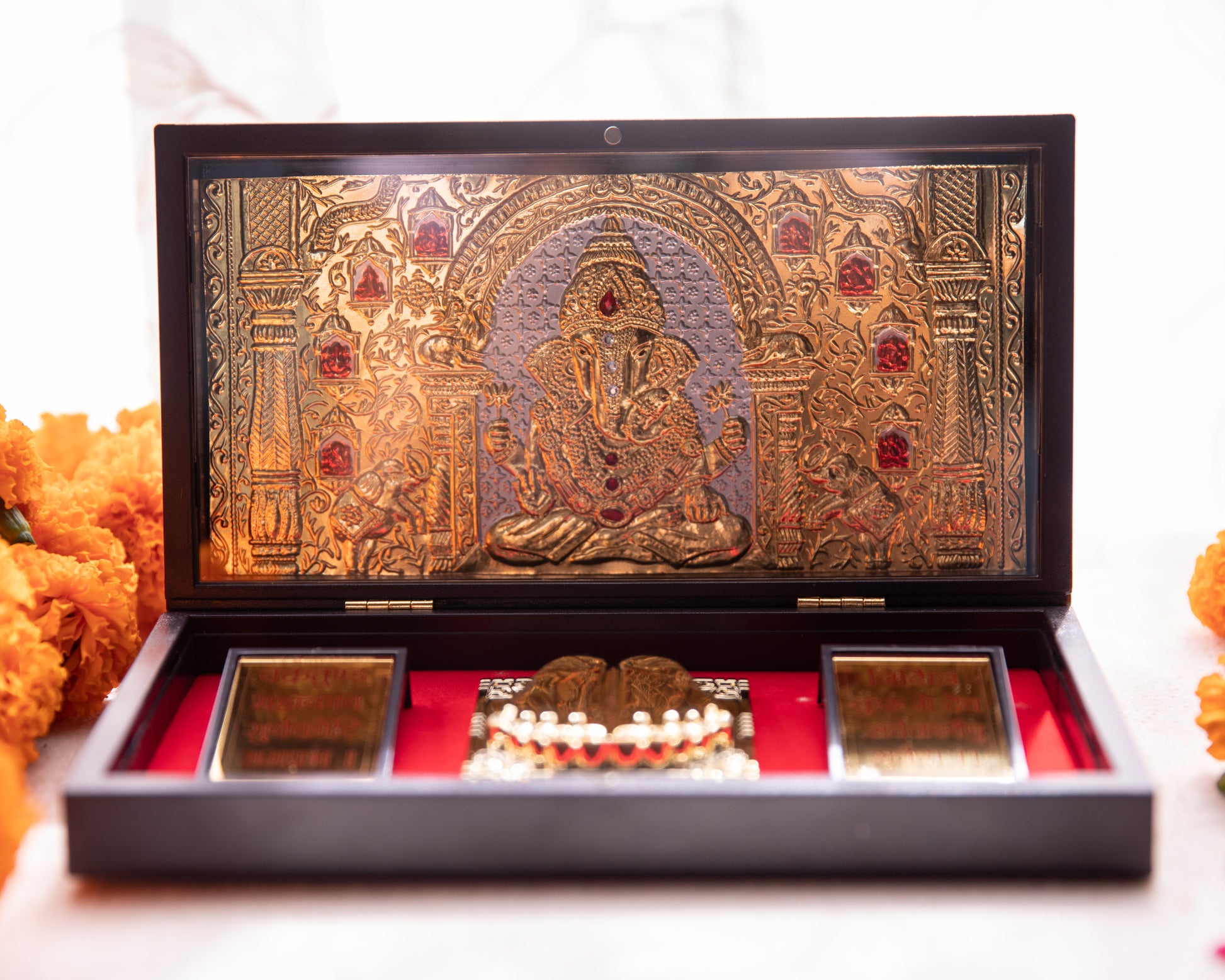 LeelaTheStore’s 24K Lord Ganesha Pooja Box - All the symbolism and imagery seen within has been wrapped in 24KT gold foil, while the box is made of wood.
