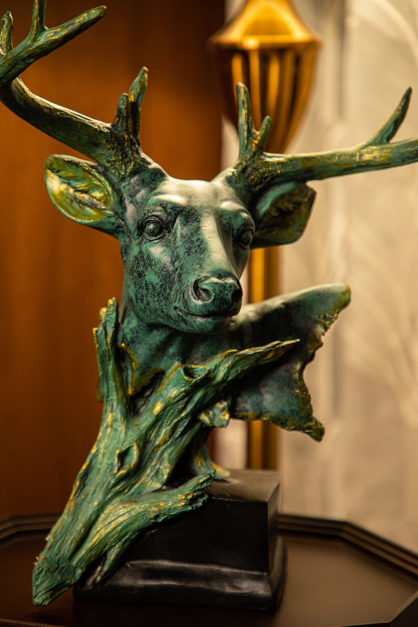 The sculpture is meticulously crafted, with intricate details that showcase the natural beauty of the deer.