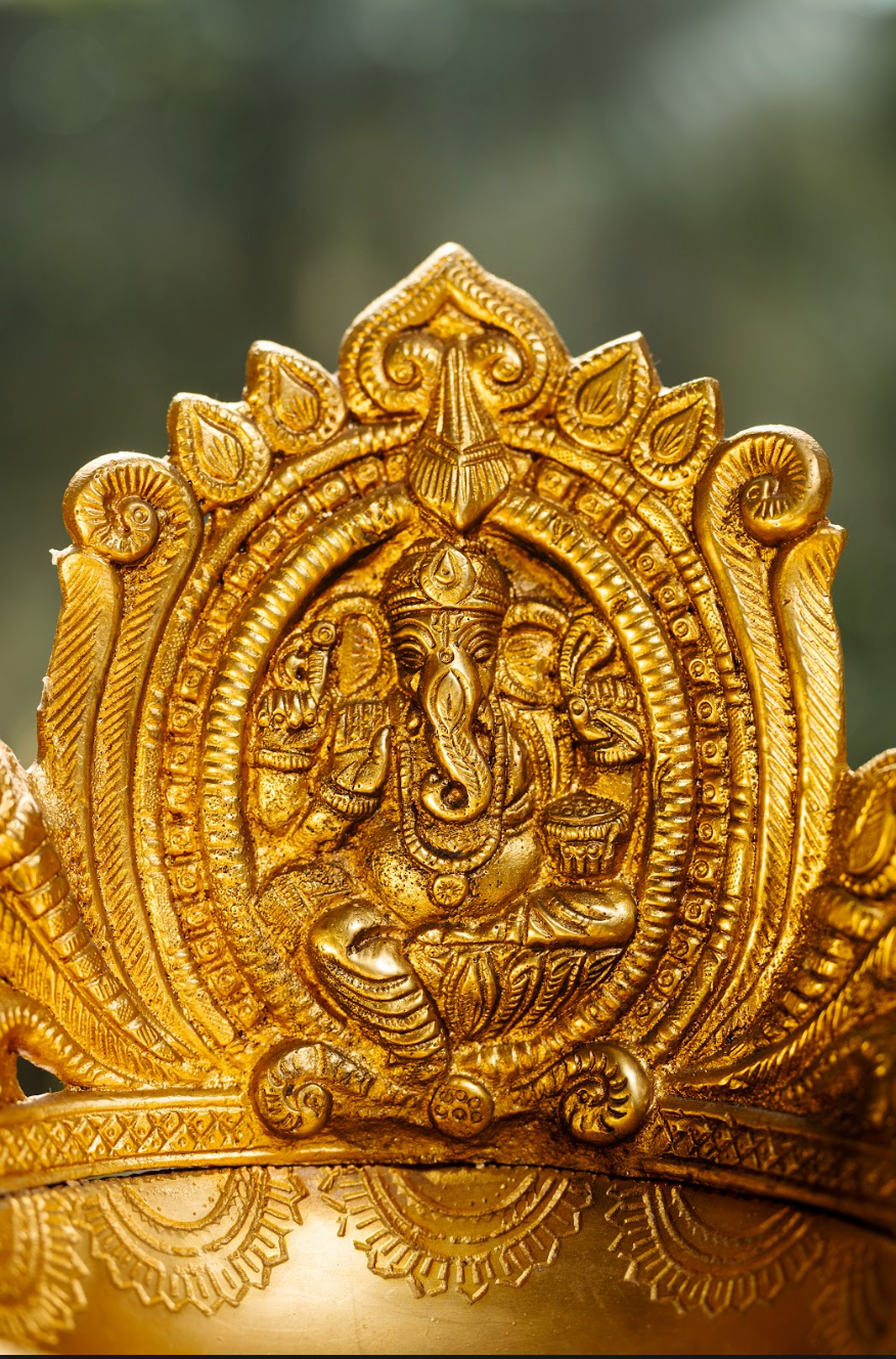 Handcrafted, this diya features a beautifully detailed Ganesh idol, symbolizing prosperity and wisdom. The intricate craftsmanship is evident in the fine details, from the deity’s form to the ornate carvings that surround the lamp.