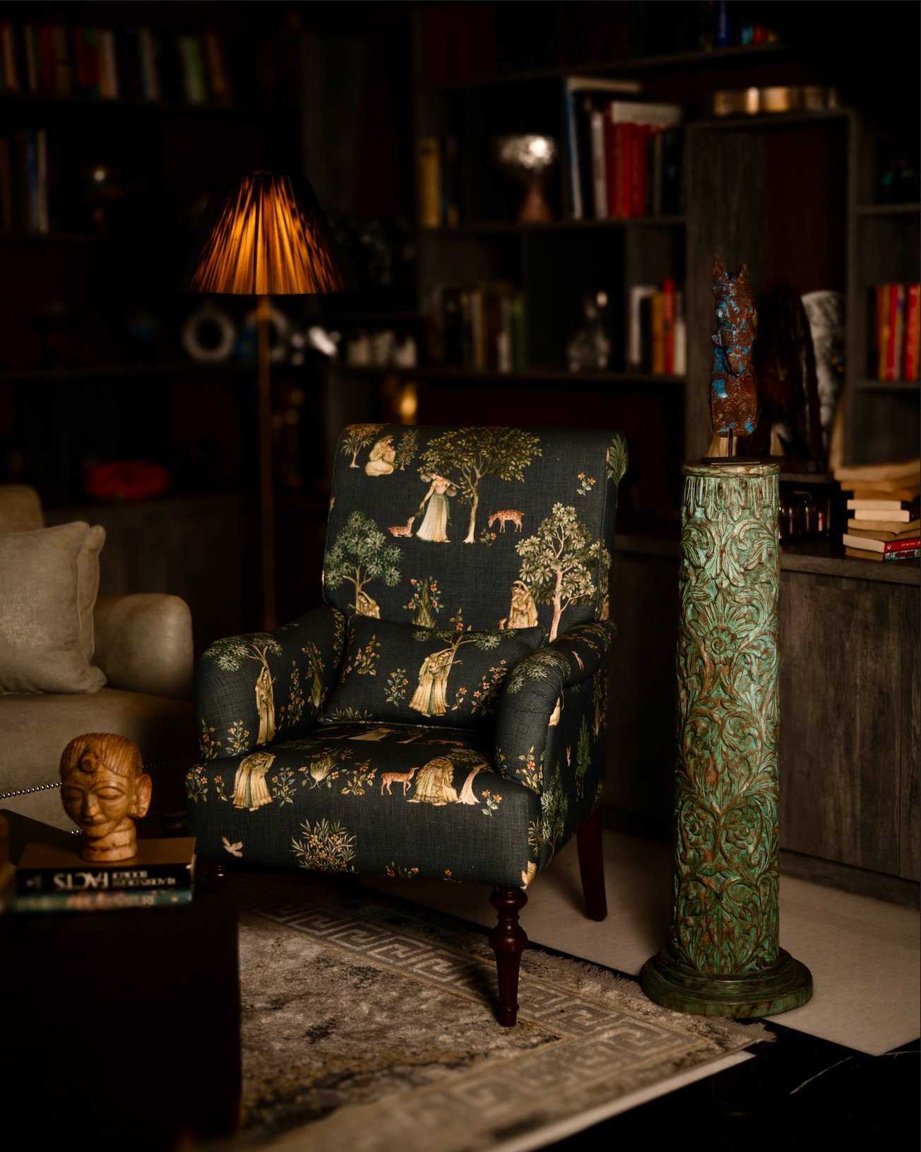 The Pushpa Stambh is a grand wooden pillar that carries the elegance of hand-carved floral motifs, flowing across its tall frame like a garden in bloom. Its natural greenish-blue patina, derived from plant-based pigments, enhances the depth of each carving while adding a soft vintage character. 