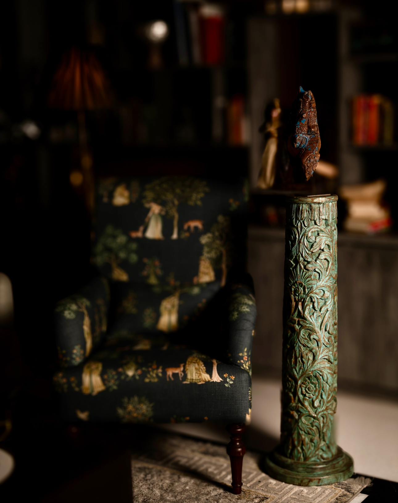 The Pushpa Stambh is a grand wooden pillar that carries the elegance of hand-carved floral motifs, flowing across its tall frame like a garden in bloom. Its natural greenish-blue patina, derived from plant-based pigments, enhances the depth of each carving while adding a soft vintage character. 
