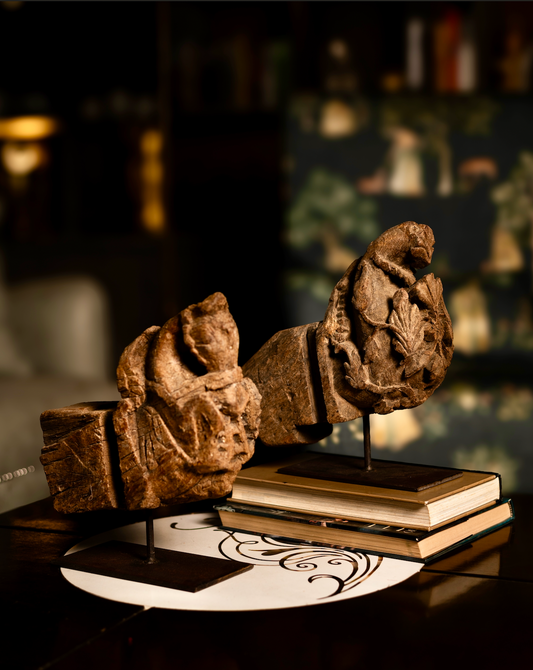 The Rūpa Shilp Sculptures are salvaged wooden fragments reimagined as collectible art. Hand-carved with distinct motifs — one a stylised horse face symbolising vitality and endurance, the other a blossoming flower representing beauty and renewal.
