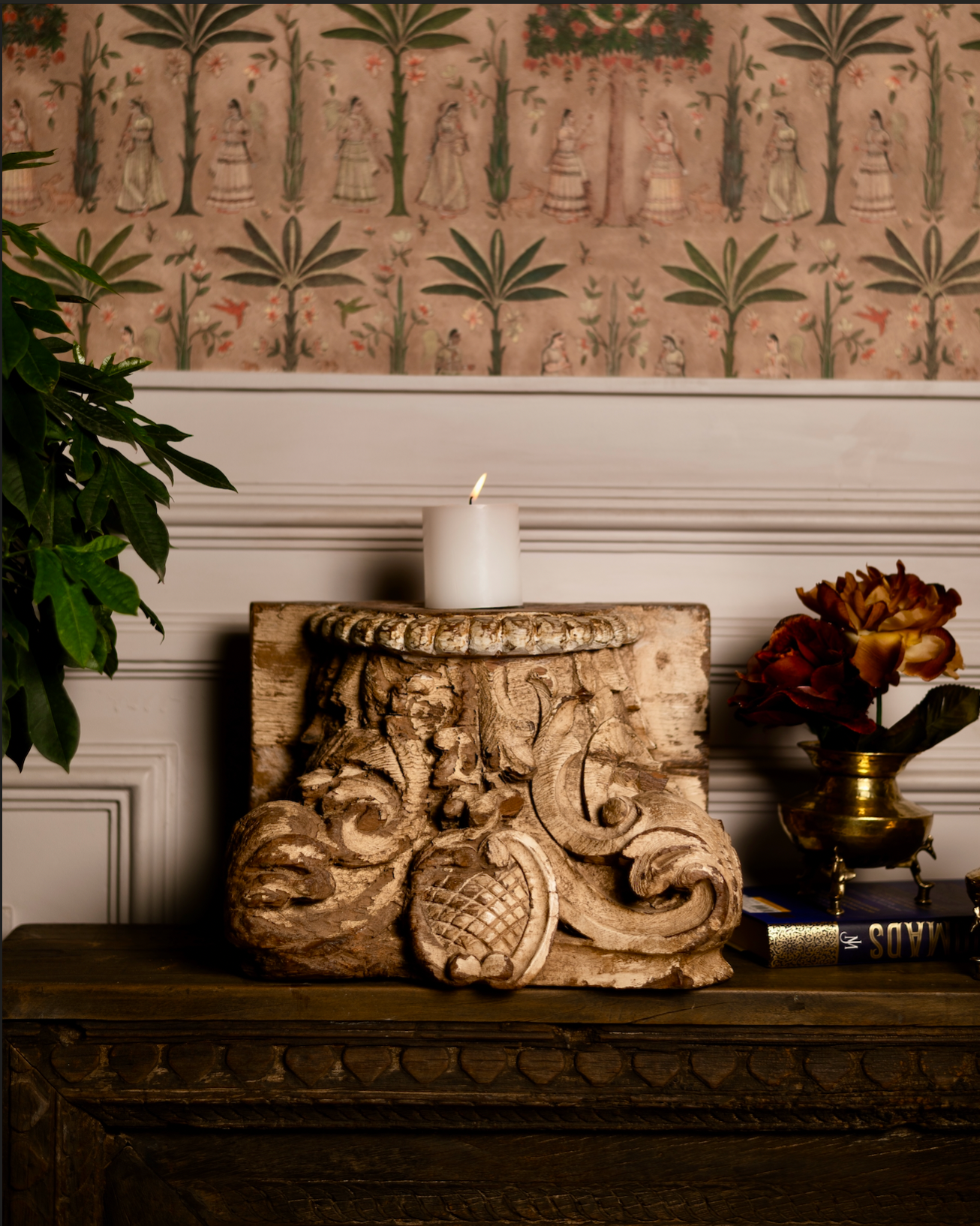 The Kusum Stambh Candle Pedestal is a stunning fragment of architectural heritage, hand-carved from solid reclaimed wood. With its ornate scrolls, floral accents, and natural distressed finish