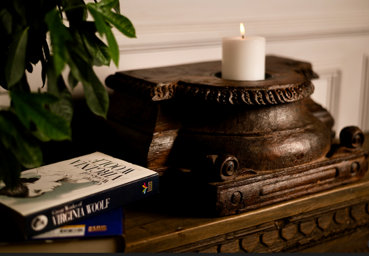 An antique wooden pedestal reimagined as a candle holder, Jyotirmay carries the glow of heritage and the warmth of tradition. Its hand-carved details and deep, rich patina make it a timeless accent for your living space. 