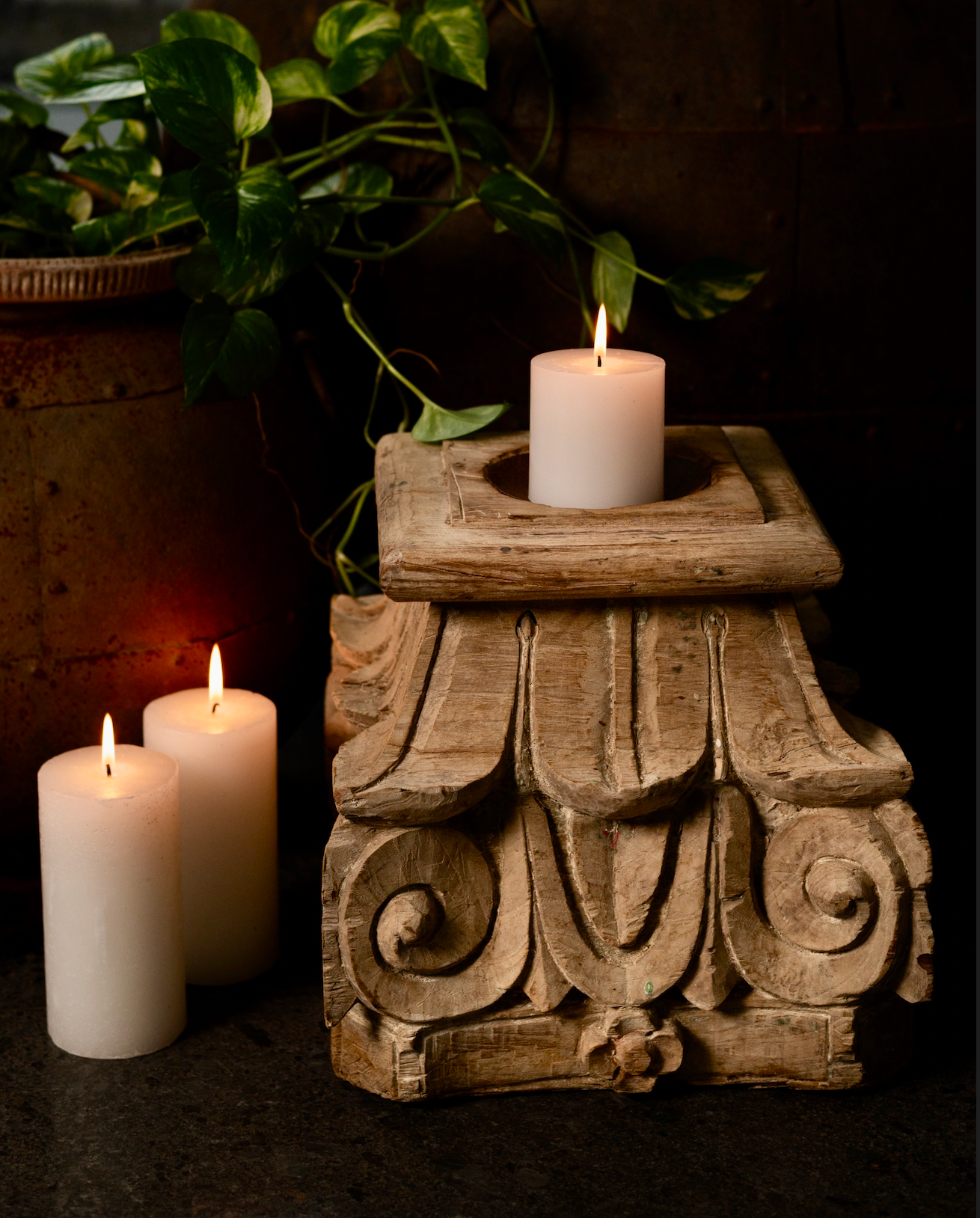 The Stambh Jyoti Candle Pedestal draws its inspiration from classical Indian architecture — carved from solid wood and finished in natural, earthy tones
