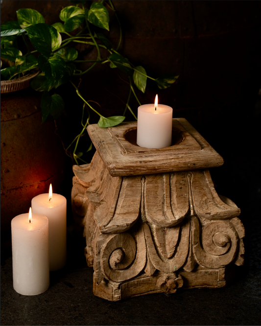The Stambh Jyoti Candle Pedestal draws its inspiration from classical Indian architecture — carved from solid wood and finished in natural, earthy tones