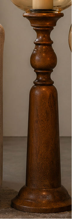 Turned wooden candle stands topped with hand-blown amber glass globes, designed to hold pillar candles at a graceful height. 