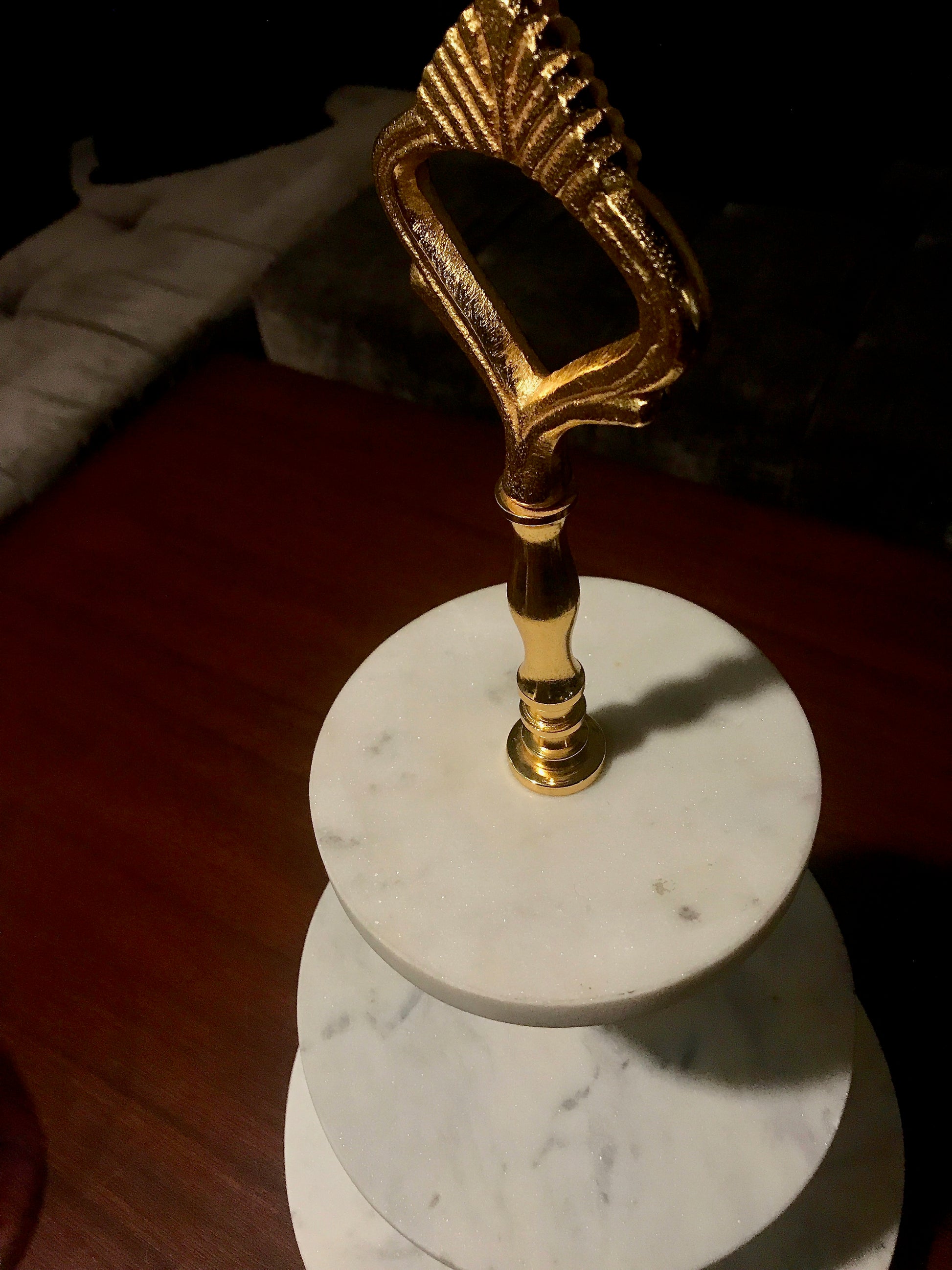 A Marble cake stand with a brass stem with 24ct polish to support the structure.