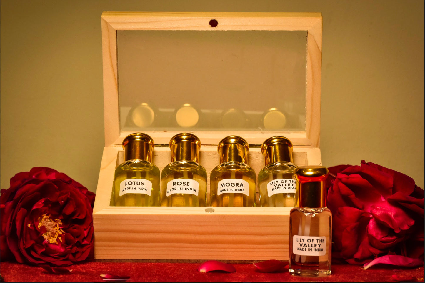 A collection of four floral scents contained in a wooden box.