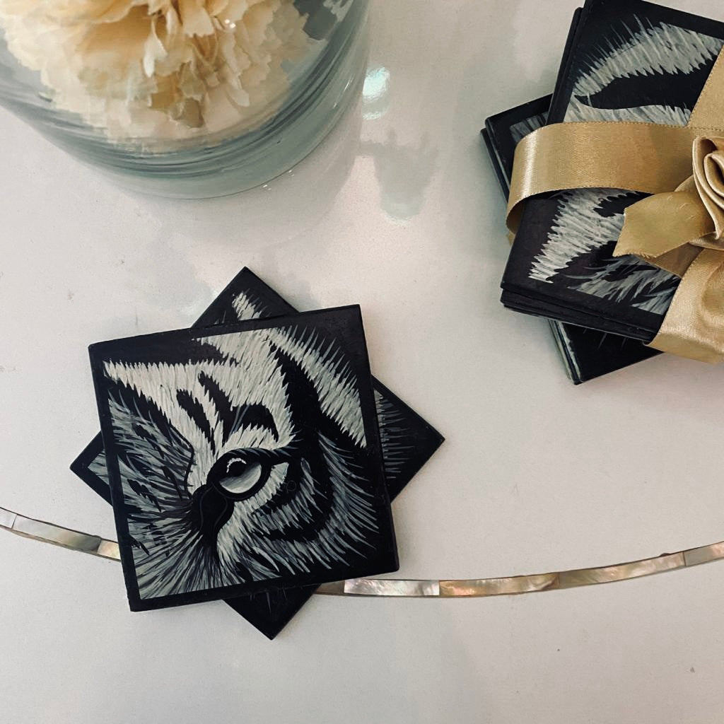 A Marble Coaster Set of 4, with handpainted detail of the close up of a tiger's eye, in black & White. 