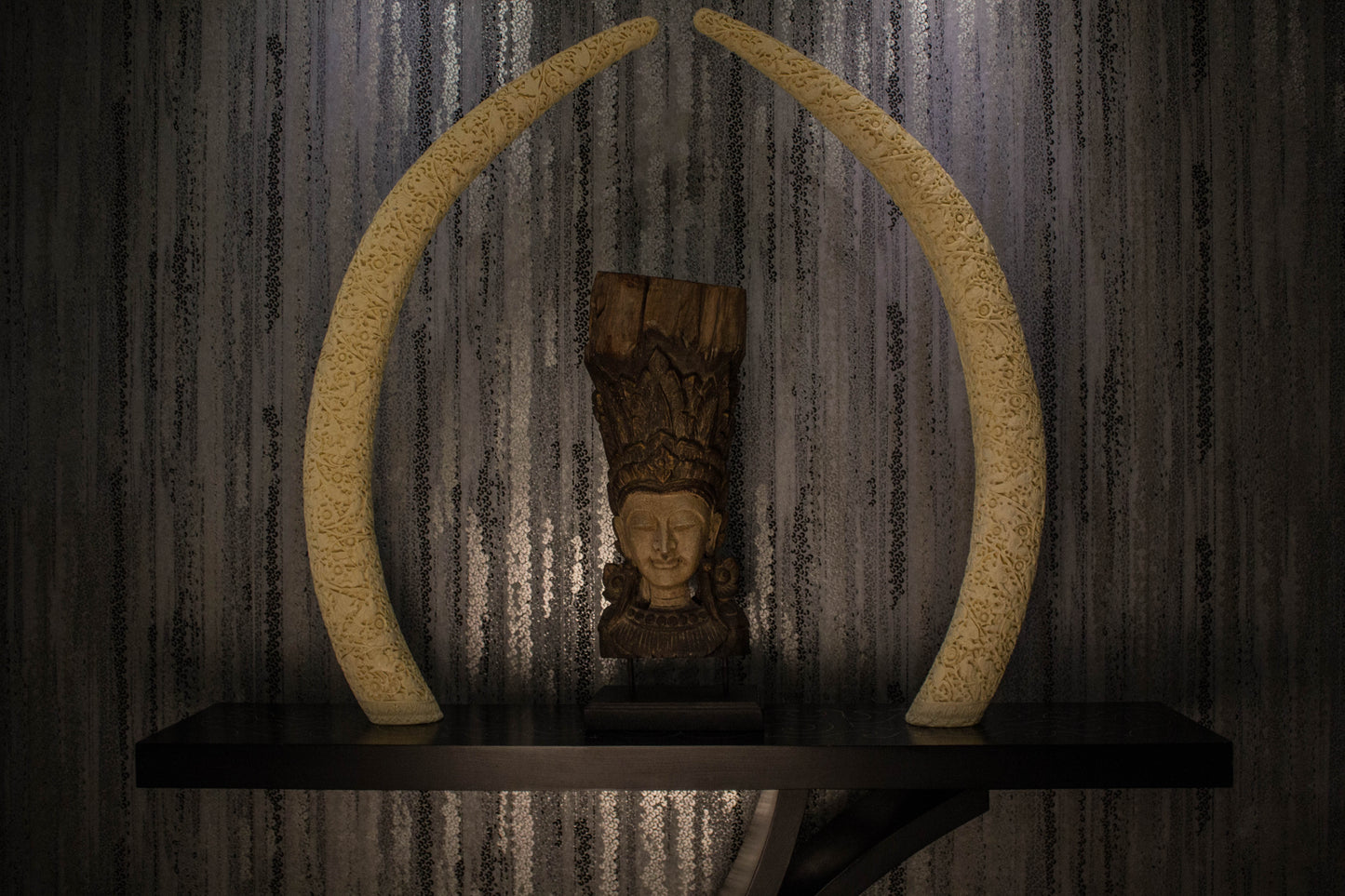 A true object d'art. Carved on a camel bone, the intricate work is inspired by carvings done in ancient times as a symbol of wealth & privilege. A single tusk is majestic on a consol