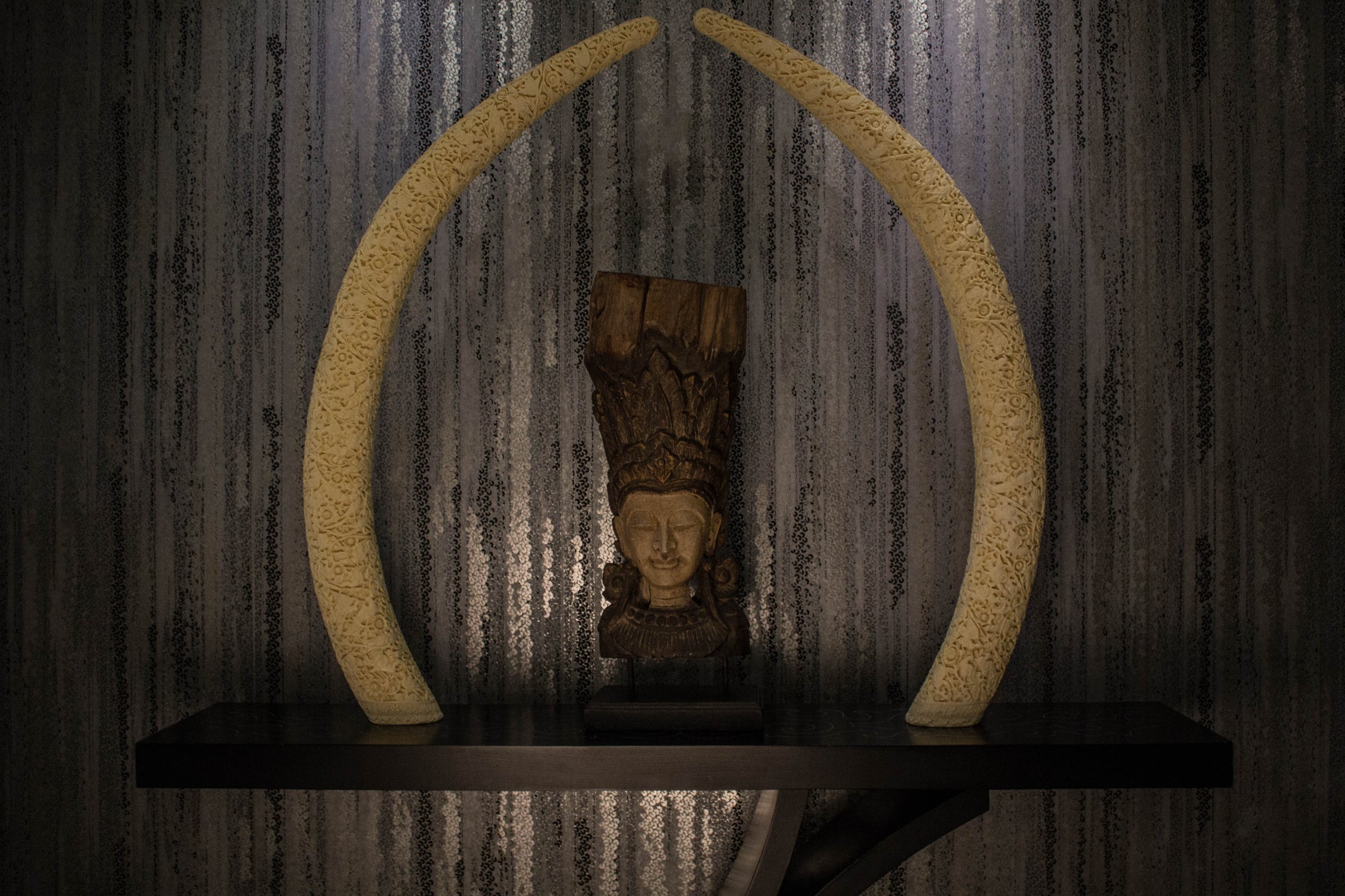 A true object d'art. Carved on a camel bone, the intricate work is inspired by carvings done in ancient times as a symbol of wealth & privilege. A single tusk is majestic on a consol
