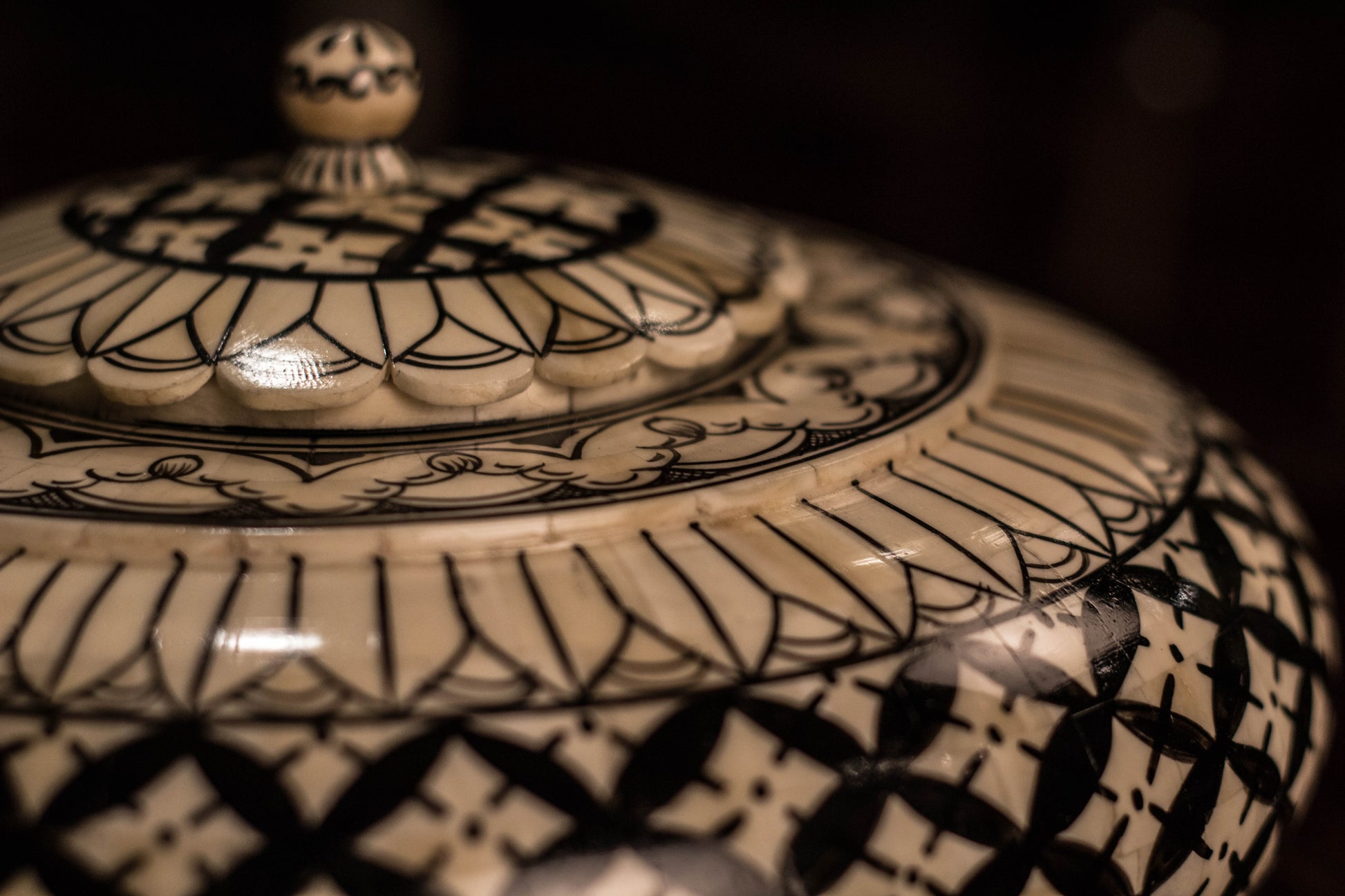 A black & white Camel bone decorative accessory pot.