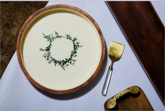 A Round wooden tray with a ceramin inlay with designs inspired by the greek culture and 100% food safe. Can be used as a decorative tray or a lap tray. 