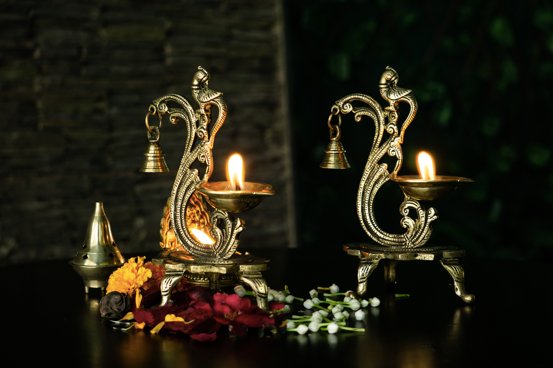 Brass Diyas with a bell Detail with an antique gold finish.